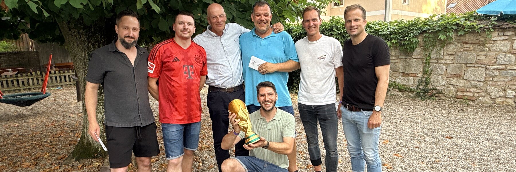 The winning team of the live table football tournament together with the CFO and their prizes.