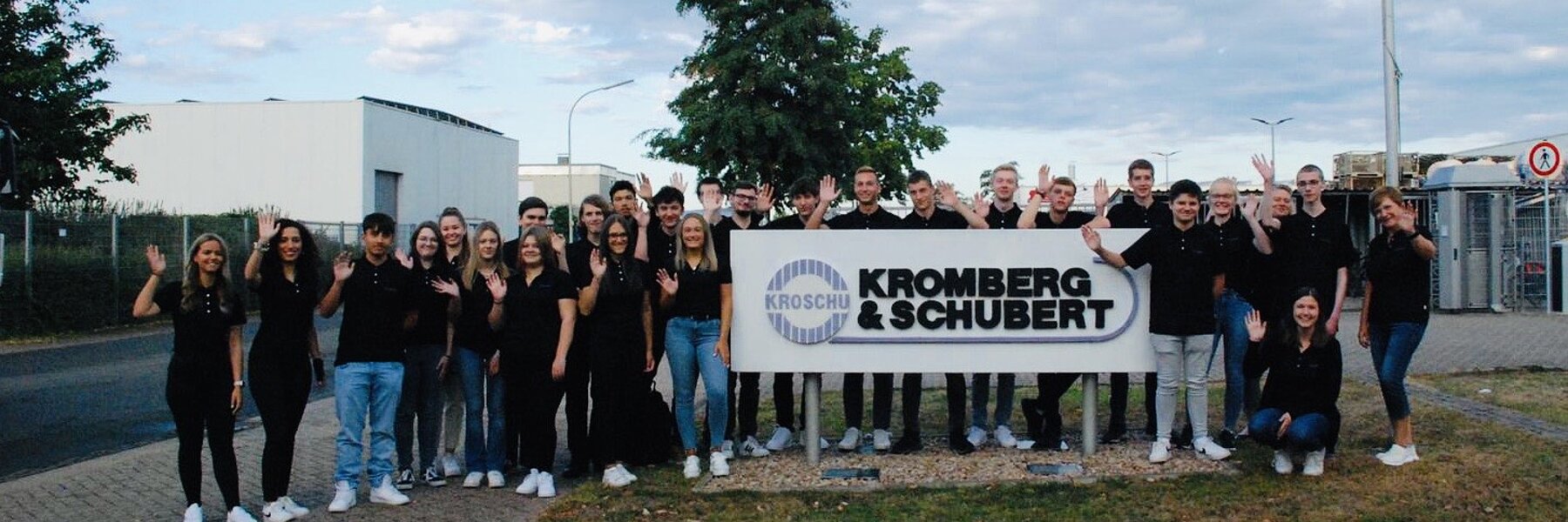 Group of all german trainees in front of the plant